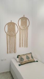 a white room with curtains on the wall at Alexandra's Boutique House in Triovasálos