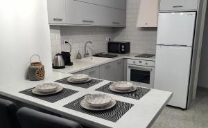 a kitchen with a table with plates on it at Alexandra's Boutique House in Triovasálos