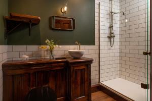 a bathroom with a sink and a bath tub at Gwynfryn in Conwy