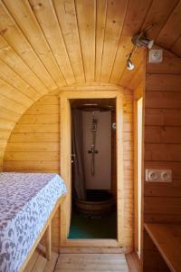 a small room with a shower in a wooden house at Les Tonneaux Bourguignons du Carré Saint Pierre in Marey-lès-Fussey