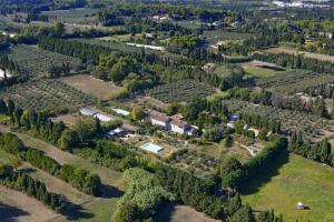 an aerial view of an estate with trees at Mas des Figues #PhilippeArtist #bio-organiccertified #potagerbio #huiledolivebio #mediterraneandietbrunch #farmtofork #homemadecooking #biodiversity #roseraie #ecologicalgarden #agritourism #ecotourism #farmstay #guesthouse #saintremydeprovence #Alpilles in Saint-Rémy-de-Provence