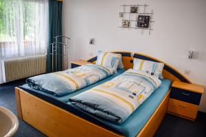 a bed with two pillows on it in a room at Apartments Alpenfirn Saas-Fee in Saas-Fee