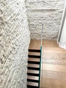 a staircase in a room with a stone wall at Soho Boutique apartments in London