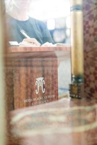 a table with a sign on top of it with a napkin at Hotel Moroccan House in Casablanca