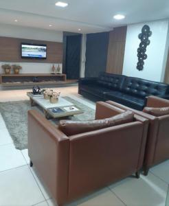 a living room with a couch and a table at Charmoso Apt 412 in João Pessoa