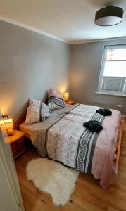 a bedroom with a bed and a window and a rug at Ferienhaus Darlingerode in Darlingerode