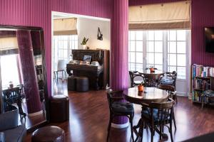 a room with a table and chairs and a piano at Hotel Leiria Classic in Leiria