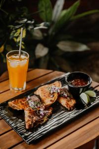 a plate of food on a table with a drink at The Golden Frog Inn in Valle de Anton