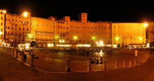 a group of buildings at night with lights at Vacanze Senesi in Siena
