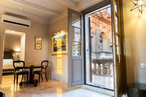 a dining room with a table and a glass door at The Xara Palace Relais & Chateaux in Mdina