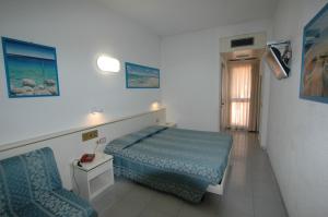 - une petite chambre avec un lit et une chaise dans l'établissement Hotel Crystal, à Portoferraio
