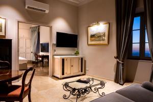 a living room with a couch and a table at The Xara Palace Relais & Chateaux in Mdina