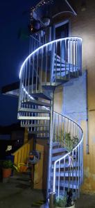 a blue spiral staircase on the side of a building at Ilkas Inn in Vielbrunn