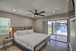 a bedroom with a bed and a ceiling fan at Canal-Front Cape Coral Home: Pool & Patio in Cape Coral +18 photos