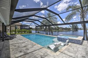 a swimming pool with a view of the water at Canal-Front Cape Coral Home: Pool & Patio in Cape Coral