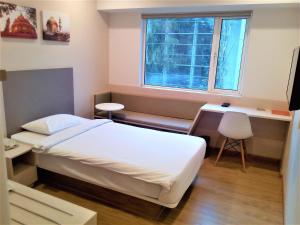 Postel nebo postele na pokoji v ubytování Ginger Pune - Pimpri