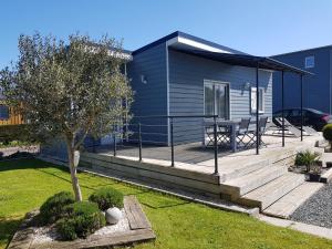 a house with a deck with a table on it at Cottage sword beach in Hermanville-sur-Mer
