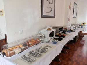 a long table filled with food and a microwave at La Luna Blanca in Torremolinos