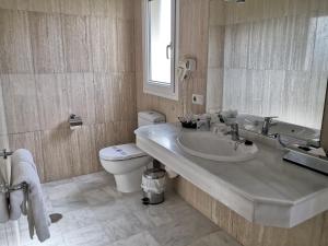 a bathroom with a sink and a toilet at La Luna Blanca in Torremolinos