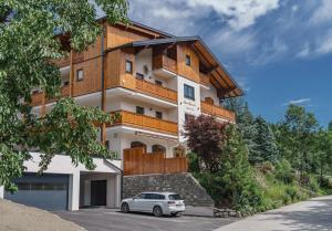 a house with a car parked in front of it at Unser Hoamat Appartement in Schladming