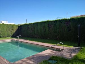 a swimming pool with two faucets in a yard at La Luna Blanca in Torremolinos
