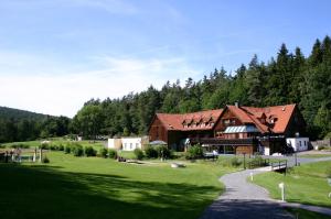 a large building in the middle of a green field at Hotel Im Krummbachtal in Schönau an der Brend