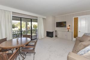 a living room with a table and a fireplace at 305 Northgate at Silverado in Napa condo in Napa