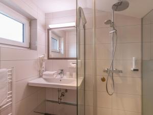 a bathroom with a sink and a shower at das Christophorus in Söll