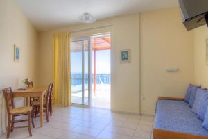 a living room with a bed and a table and a dining room at Atlantis in Plakias +21 photos