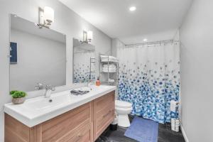 a bathroom with a sink and a toilet and a shower at Dave and Busters, Outlets, Convention Center across street w Parking - Sleeps 15 in Atlantic City +24 photos