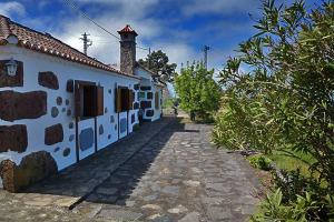 a white building with a tower on the side of it at Casa María Presentación in El Castillo