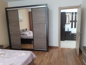 a mirror in a room with a bed and a bedroom at CASA LIVIA in Slatina