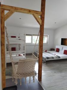 a room with two beds and a swing at Beskidzka Guest House in Szczyrk