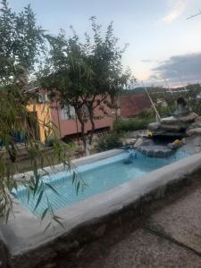 a swimming pool in a backyard with a water park at Casa Darius in Orşova