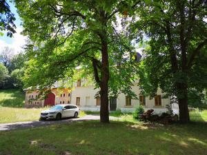 a white car parked in front of a house at Wanderlust in Thermalbad Wiesenbad