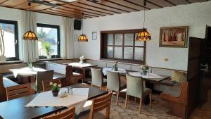 a dining room with tables and chairs in a restaurant at Hotel Gasthof Sonnenhang in Denkendorf