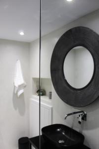 a bathroom with a black sink and a mirror at Belvedere Studios in Astypalaia Town