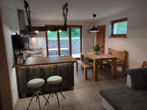 a kitchen and living room with a table and chairs at Green Garden Apartment in Bled +22 photos