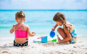 two little girls playing in the sand on the beach at Grillo Superior Apartments - Enjoy Your Life! in Capo Vaticano