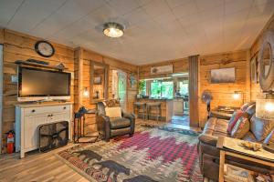 a living room with a fireplace and a tv at Adirondack Mountains Cottage Near Gore Mountain! in Warrensburg