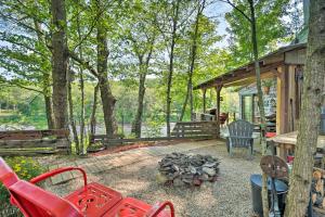 a backyard with a fire pit and a cabin at Adirondack Mountains Cottage Near Gore Mountain! in Warrensburg