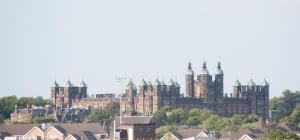 a large castle on top of a city at Stunning View - Jura - Private Members Club in Edinburgh
