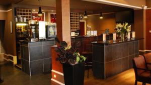 a bar in a restaurant with a counter at Great Western Hotel Aberdeen in Aberdeen