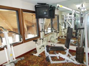 un gimnasio con máquinas de correr y TV. en Royalton Inn and Suites, Wilmington,Ohio, en Wilmington