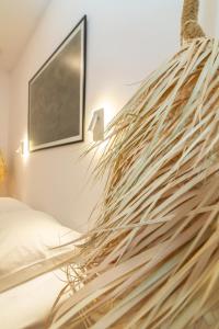a bedroom with a large piece of drift wood on the wall at Acanthus Houses in Tinos Town