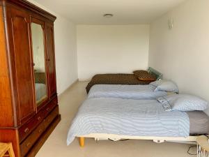 a bedroom with two beds and a dresser at Magnifique villa de charme avec piscine in Casteljaloux +25 photos