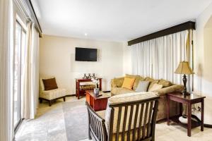 a living room with a couch and a tv at The Cove 1 at Playa Ocotal in Ocotal