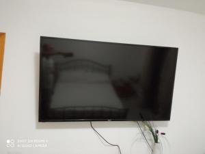 a flat screen tv hanging on a white wall at Le Case di Zu Zù in Mascali