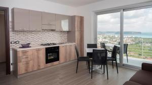 a kitchen and dining room with a table and chairs at Santo Stefano Club in Praia a Mare