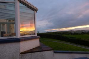 a sunset seen through a window of a house at Finn McCools Giants Causeway Hostel in Bushmills